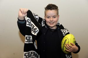 Junior mascot Cody runs in with Pies