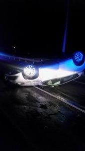 Car overturns in middle of road