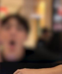 Kids cough in face of kiosk worker